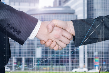 Two businessmen partners are shaking hands.