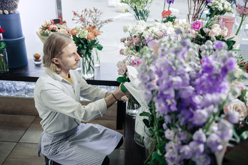 Profile photo of attentive florist that taking bouquet