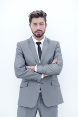 Confident bearded businessman standing with arms crossed