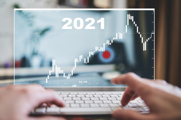 Business at home. Trading chart concept. Financial market chart. 3D rendering. Young man sitting with laptop 2021
