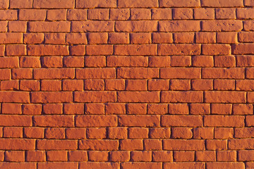 Red brick wall illuminated by the sun, texture