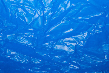 Wrinkled blue plastic sheet for background or text