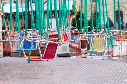 Multicolored child seats on the carousel