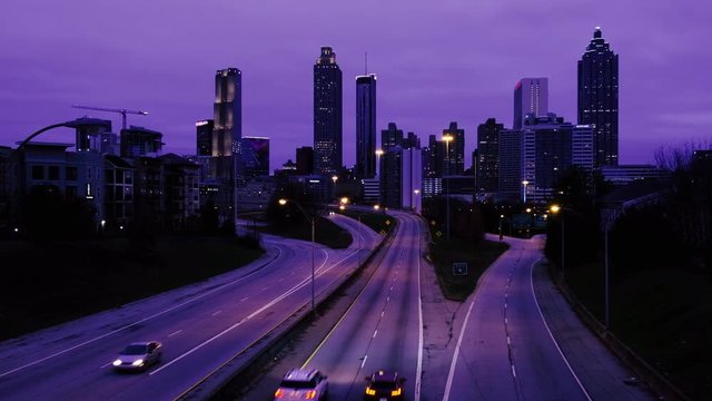 Car traffic moving towards the Atlanta Georgia downtown modern skyline at night. USA