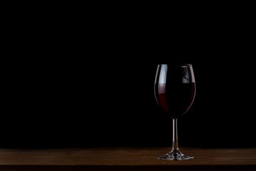 Glass of wine on black background