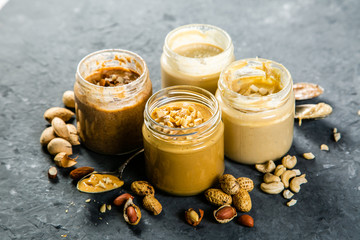 Selection of nut butters - peanut, cashew, almond and sesame seeds, copy space
