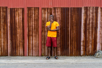 Young black African man standing while thinking against old rust