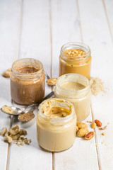 Selection of nut butters - peanut, cashew, almond and sesame seeds, copy space