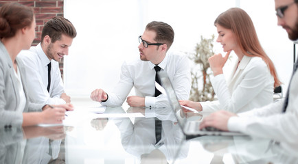 businessman talking with employees at a business meeting