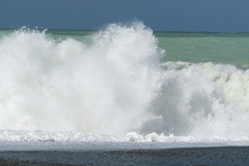 Large breaking waves on shingle foreshore