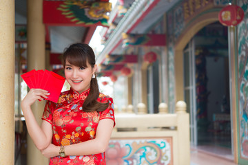 Portrait of beautiful asian woman in Cheongsam dress,Thailand people,Happy Chinese new year concept