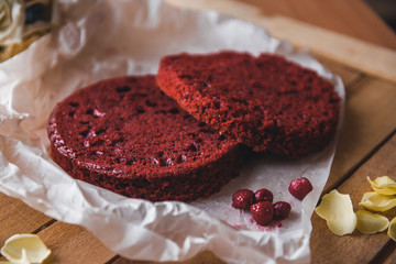 Red cake tarts on a parchment on a wooden table
