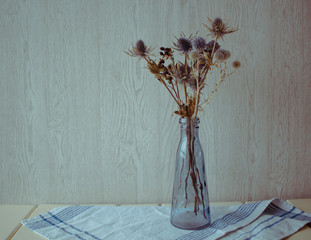wild flowers in a blue vase in an interior