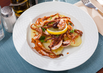 Fried octopus tentacles with potatoes