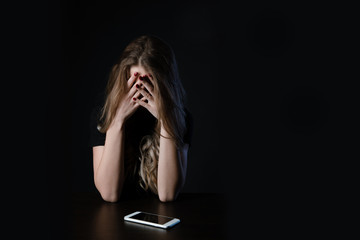 Woman with negative surprised face looking something in smartphone. Sad teenager with mobile phone, scared of threatening, mobile abuse. Front view of a sad teen checkin