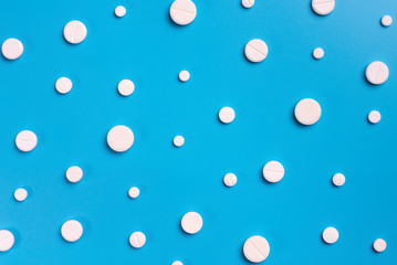 Pills, tablets on blue background