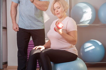 Woman doing strength exercises with dumbbells