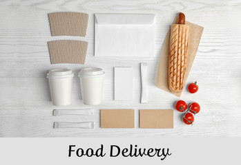 Flat lay composition with items for mock up design on wooden background. Food delivery service