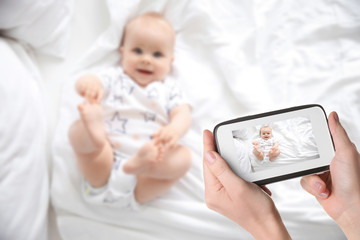 Cute little baby lying on bed, top view