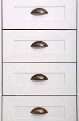 White wardrobe drawers as background, closeup view