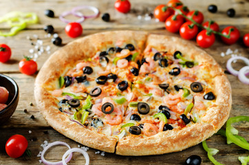 Pizza with shrimp, olives, green pepper and onion
