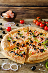 Pizza with shrimp, olives, green pepper and onion
