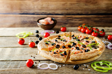 Pizza with shrimp, olives, green pepper and onion