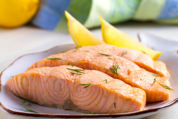 Poached salmon fillet. Boiled salmon on white plate. Good for health diet fish. View from above,...