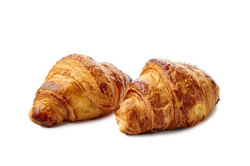 Two fresh crispy croissants on white background