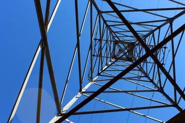 electricity pylon against blue sky