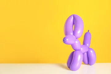 Gardinen Animal figure made of modelling balloon on table against color background. Space for text © New Africa