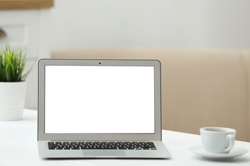 Fototapeta premium Laptop with blank screen on table indoors. Space for text