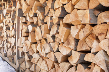 Stacked firewood outdoors, closeup. Heating house in winter