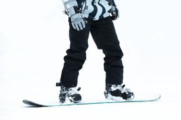 Snowboarder on slope at resort, closeup. Winter vacation