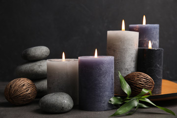 Spa composition with burning candles on table