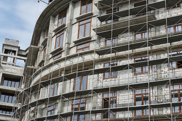 new building under construction, scaffolding and concrete