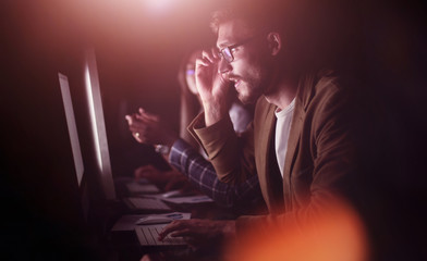 tired employees working in the office at night