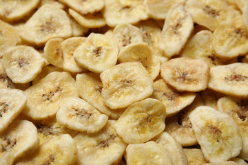 Fototapeta na wymiar Sweet banana slices as background. Dried fruit as healthy snack