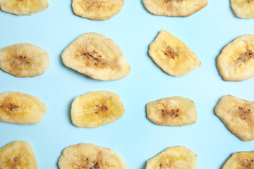 Flat lay composition with banana slices on color background. Dried fruit as healthy snack