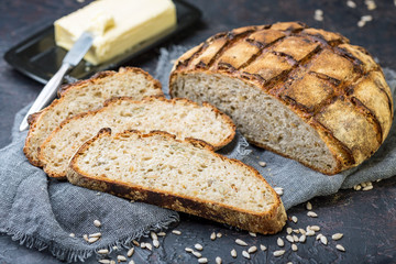 Artisanal rustic bread with seeds close-up.
