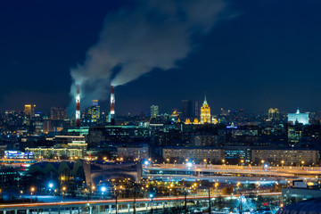 Panoramic view of night Moscow. Big city lights. Steam comes from the CHP pipes.
