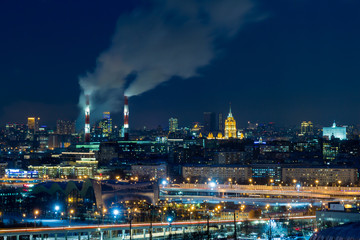 Fototapeta premium Panoramic view of night Moscow. Big city lights. Steam comes from the CHP pipes.