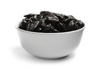 Bowl of tasty prunes on white background. Dried fruit as healthy snack