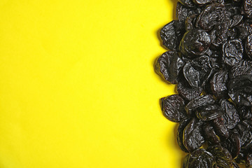 Tasty prunes on color background, top view with space for text. Dried fruit as healthy snack