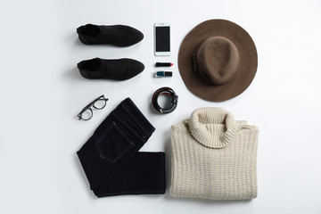 Flat lay composition with female winter clothes on white background