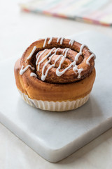 Homemade Fresh Cinnamon Roll / Bun with Cream Sauce served with Marble Board.