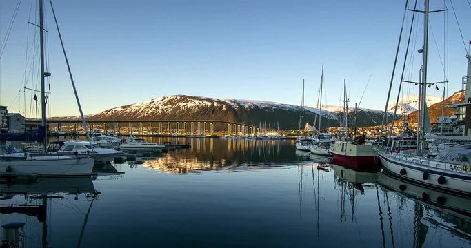 Yachts in the marina on the Lofoten islands, Yachts on the dock in the Tromso time lapse, View of a marina in Tromso at sunset