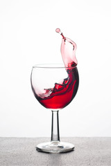 red wine in a glass with splashes