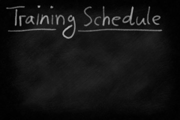 Fototapeta premium Training schedule headline on an emmtpy blackboard