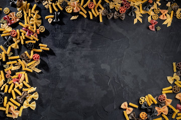 Variety of types and shapes of Italian pasta. Dry pasta background. Italian food concept. Top view with free space for menu or recipes
